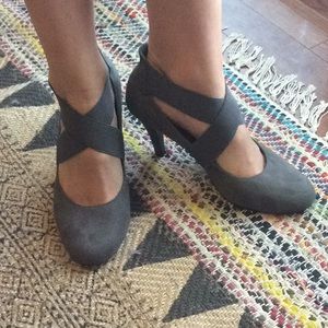 Suede grey pumps with crisscross straps.